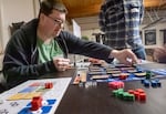 A member of the Stumptown Gamecrafters' Guild plays through the latest iteration of Justin Cyr’s "AstroTech" during a meet up in Tigard, Ore., on Dec. 9, 2024.