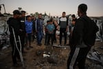 Displaced Palestinians inspect the damage after an Israeli army strike on their tent camp in Deir al-Balah, Gaza Strip, Wednesday.