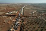 An aerial view shows people crossing an antigovernment checkpoint as they return to Saraqib in the eastern part of Idlib province in northwestern Syria on Dec. 1.