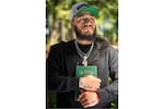 Gabriel Martinez Garcia, 30, holds a Bible close to his chest as tattoos of his parents are visible on his wrists, in Tenino, Wash., on Sunday, June 14, 2026.