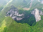 An aerial photo taken in April 2020 shows the scenery of a giant karst sinkhole in China's Guangxi Zhuang Autonomous Region. A similar sinkhole was found earlier this month with an ancient forest at the bottom with trees towering over 100 feet tall.