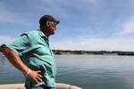 FILE - Willie Levenson with the Human Access Project stands on a boat inside Ross Island Lagoon on the Willamette River during an algae bloom in the summer of 2021.