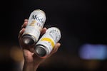 A vendor holds up a Modelo Especial beer and a White Claw hard seltzer during a National Basketball Association game between the Portland Trail Blazers and the Toronto Raptors at the Moda Center in Portland, Ore., Wednesday, Nov. 13, 2019. The Moda Center began selling White Claw in 2019.