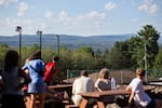 Volleyball spectators enjoy the action below while the surrounding mountains provide the perfect backdrop, reminding Soyuzivka’s founders of their beloved Carpathian Mountains.