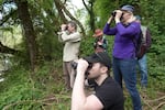 Volunteers at the 2024 Kellogg Creek BioBlitz survey waters for signs of any birds on May 18, 2024. Groups spent the morning counting various species in the area.