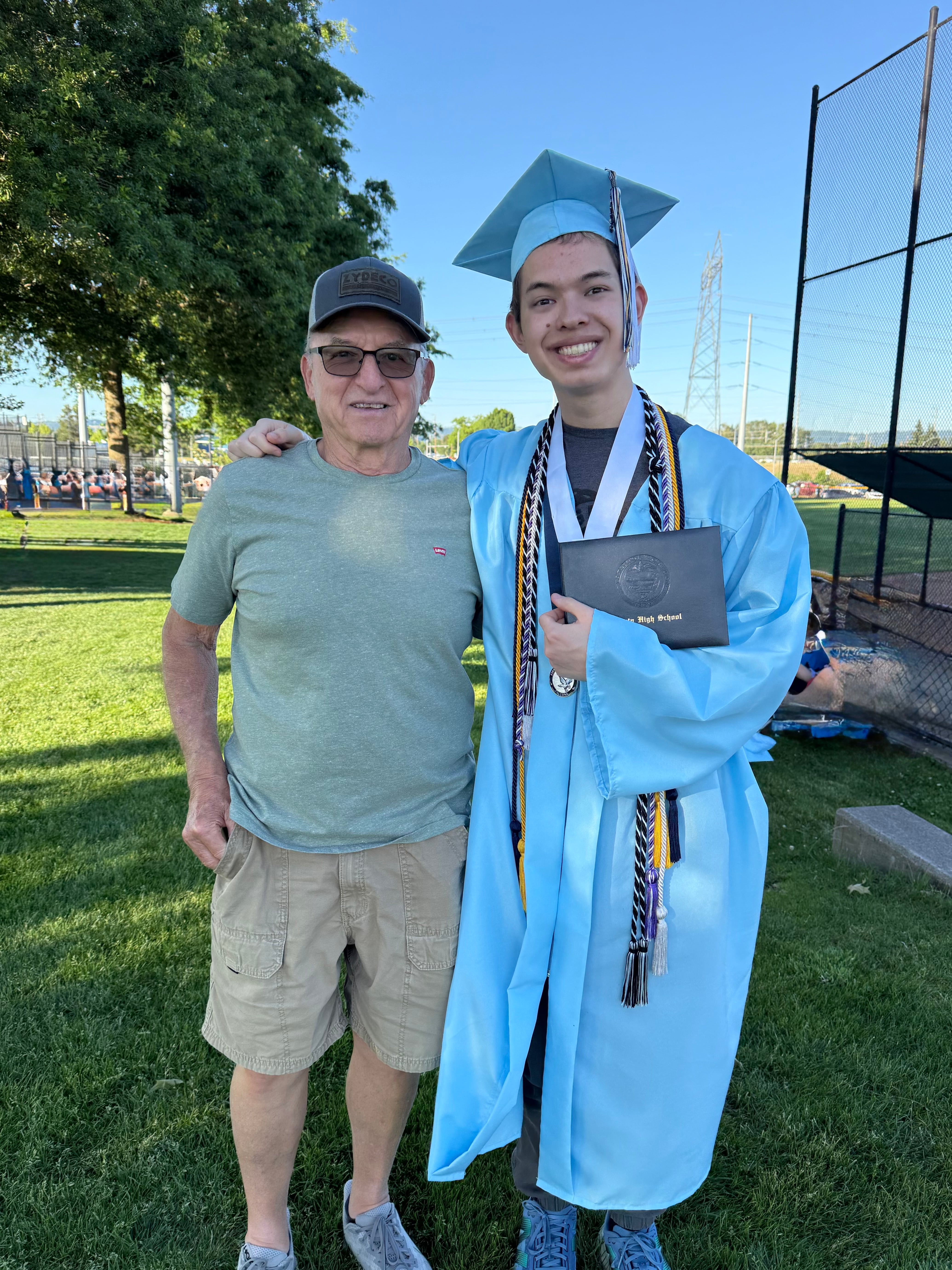 Kal Sibbel, a Liberty High School valedictorian, right, poses with his grandfather at his graduation ceremony on June 7, 2025, in Hillsboro, Ore.