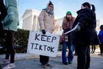 People hold a sign that reads "Keep TikTok" as they stand outside the Supreme Court Building in Washington, D.C. on Jan. 10, 2025.