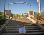 Yellow caution tape and hurdles block people from entering the Peter W. Stott Community Field on Portland State University's downtown Portland, Ore., campus on Friday, April 17, 2020. The university closed the field as part of the state's shelter-in-place efforts to slow the spread of the coronavirus.