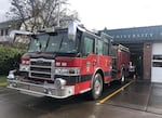 A fire engine parked in front of University Station in Eugene.