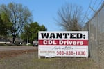 A recruitment sign for commercial truck drivers sits along Oregon Route 99 in Monmouth.