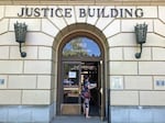 FILE - A woman enters the Oregon Department of Justice building in Salem, Ore., May 28, 2020. Roy Kaufmann, a spokesperson for the Oregon Department of Justice, which is representing the state and local judges, said the agency would appeal Thursday's order.