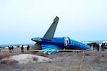 In this photo taken from a video released by the administration of Mangystau region, a part of Azerbaijan Airlines' Embraer 190 lies on the ground near the airport of Aktau, Kazakhstan, on Thursday.