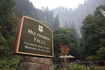 The Multnomah Falls sign on Sept. 6, 2017 as the Eagle Creek Fire looms nearby.