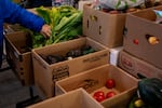 A person picks out greens at One Life Food Pantry, located in Real Life Foursquare Church in Vancouver, Wash., on Nov. 1, 2025.