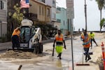 Long Beach Public Works workers clean up along Alamitos Peninsula in Long Beach, Calif. that was affected by Tropical Storm Rachel, Sunday, Oct. 11, 2026.