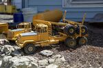 Model trucks sit in Otis Cody's front yard in Fossil, Ore., Tuesday, June 4, 2019. Cody handmakes the trucks himself down to the tiny steering wheels and moving parts.