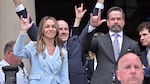 Karen Read and members of her legal team gesture to supporters with the American Sign Language "I love you" sign after she was found not guilty of second-degree murder on Wednesday, in Dedham, Mass.