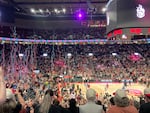 Streamers rain down on the court as Portland Fire players huddle around Sarah Ashlee Barker to celebrate her game winning shot. The Fire beat the New York Liberty 98-96 in their second official game as a new franchise on May 12, 2026 in Portland, Ore.