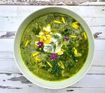 Green soup with herbs and flowers.