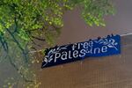 FILE: A large sign is unfurled from the roof of the building while spectators cheer, as the occupation continued at Portland State University’s Branford Price Millar Library, May 1, 2024. 