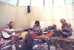 Seth Tibbot (far right) playing music in a teepee at Cherry Grove Center, 1978.