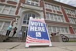 People walk into a New Orleans school to cast their votes in Louisiana's statewide primary on May 16.