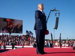 Former President Donald Trump stands while a song, "Justice for All," is played during a campaign rally at Waco Regional Airport, March 25, 2023, in Waco, Texas. The song features a choir of men imprisoned for their role in the Jan. 6, 2021, insurrection at the U.S. Capitol singing the national anthem and a recording of Trump reciting the Pledge of Allegiance.