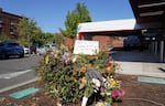 A pile of flowers and a note eulogizing Bobby Smallwood, a security officer for Legacy Health, sit outside the Good Samaritan Medical Center, where he was killed during a confrontation on July 30, 2023.