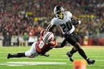 Wisconsin's Austin Brown (9) stops Oregon's Jordan James (20) during the second half of an NCAA college football game Saturday, Nov. 16, 2024, in Madison, Wis. Oregon won 16-13.