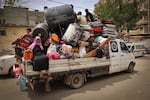 Palestinians pile their belongings on a vehicle as it drives to safer areas in Rafah, in the southern Gaza Strip, on Friday.