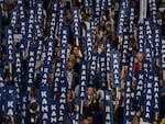 Attendees of the DNC hold up "Kamala" signs.