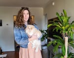 Susan Burke is trying to sell her extra Beyoncé tickets on StubHub, but they are not showing up for most users. In this photo, Burke is posing with her cat, Peaches.
