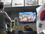 Visitors watch a news broadcast showing file footage of a North Korean missile test at the ferry terminal of South Korea's eastern island of Ulleungdo, in the East Sea, also known as the Sea of Japan, on Thursday.