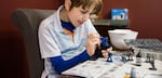 Ten-year-old Landon paints a model at his family's dining room table in Vancouver, Wa., Thursday, Feb. 28, 2019.