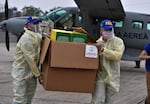 Members of the Honduran Armed Forces carry a box containing some of the 8000 diagnostic testing kits donated by the United States Agency for International Development (USAID) and the International Organization for Migration (IOM) to Honduras to fight the COVID-19 coronavirus pandemic, at the airport in Tegucigalpa on April 29, 2020. - The novel coronavirus has killed at least 224,402 people since the outbreak first emerged in China in December, according to a tally from official sources compiled by AFP at 1900 GMT on Wednesday. (Photo by Orlando SIERRA / AFP) (Photo by ORLANDO SIERRA/AFP via Getty Images)