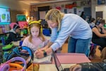 Hanna Hardwick, 8, left, gets some help from Kristina Meinecke during class at Fern Hill Elementary School in Forest Grove, Ore., Nov. 9, 2023. The PAX Good Behavior Game is used in the classroom to help students identify and encourage positive “PAX” behaviors  and avoid “spleems” as part of daily classroom management.