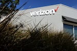 The Verizon logo is displayed on the exterior of a Verizon store. The FCC approved its $20 billion deal to buy Frontier Communications, a day after Verizon told the U.S. regulator that it would end many of its diversity-related policies. 