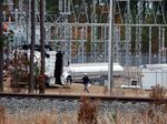 Workers work on equipment at the West End Substation in West End, N.C., on Monday, after an attack on critical infrastructure has caused a power outage to many around Southern Pines, N.C.