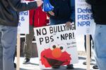 A poster at a March 26 rally to protect funding for US public broadcasters, PBS and NPR outside the NPR headquarters in Washington, DC.