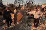 Kenneth Snowden, left, surveys the damage to his fire-ravaged property with his brother Kim, center, and Ronnie in the aftermath of the Eaton Fire Friday, Jan. 10, 2025 in Altadena, Calif.