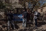 Volunteers from the organization Citizens for Europe hang up a banner on the fence of a local residence about the upcoming European Union referendum, in Rîşcani, Moldova, Oct. 13.