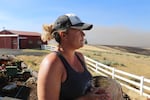 Cynthia Kortge watches the billowing wildfire smoke from her back porch in Wasco County. Her husband Jeff farms the thousands of acres of wheat on their property, most of it was destroyed in the blaze.