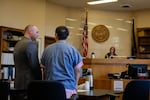 Angel Granados-Diaz, right, speaks to his attorney Adam Thayne during a plea hearing Thursday, Oct. 10, 2019, at the Multnomah County Courthouse in Portland, Ore. Granados-Diaz pleaded guilty to one felony and one misdemeanor after he brought a shotgun to Parkrose High School earlier in the year.