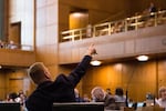 State Rep. Daniel Bonham, R-The Dalles, points to the gallery from the House floor at the Capitol in Salem, Ore., Thursday, April 11, 2019.