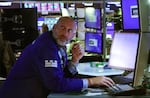 A trader works on the floor of the New York Stock Exchange.