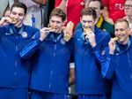 Team USA's men's swimming team stands on the podium after winning gold in the men's 400-meter freestyle relay final at the Paris Olympics on Saturday.