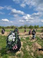 There are many fresh graves in the town's new cemetery.