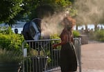 :A woman tries to cool off with a fan that spray water to refresh people during a hot day as the National Weather Service on Monday issued a warning due to hot weather that will remain in effect until Wednesday night in New York City, United States on July 15, 2024.