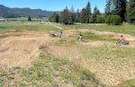 Young mountain bikers ride a skills course on June 7, 2024, behind the Nestucca K-8 School, part of the school district in southern Tillamook County near Cloverdale. Local bikers and officials hope to see the county become a popular destination for bikers.