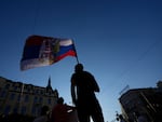 A man waves a flag combined of Russian and Serbian colors as he attends a protest against pollution and the exploitation of a lithium mine in the country, in Belgrade, Serbia, on Saturday.